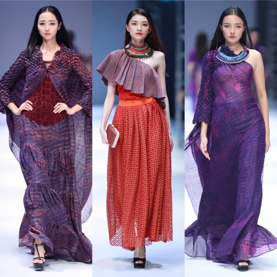 Three models wearing Eric Raisina Haute Texture dresses | Shop at The Aviary Square